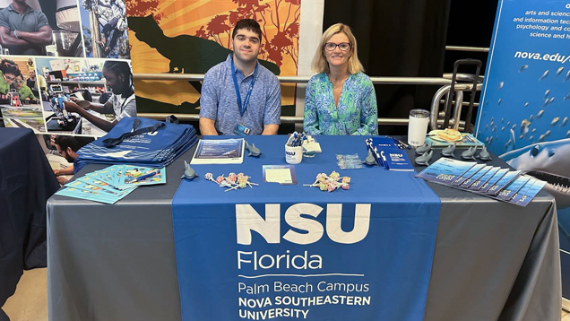 People at stem teacher open house event table
