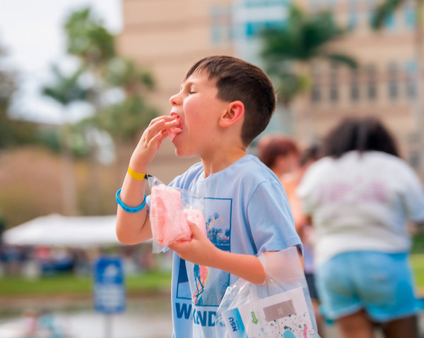 young boy eating cotton candy