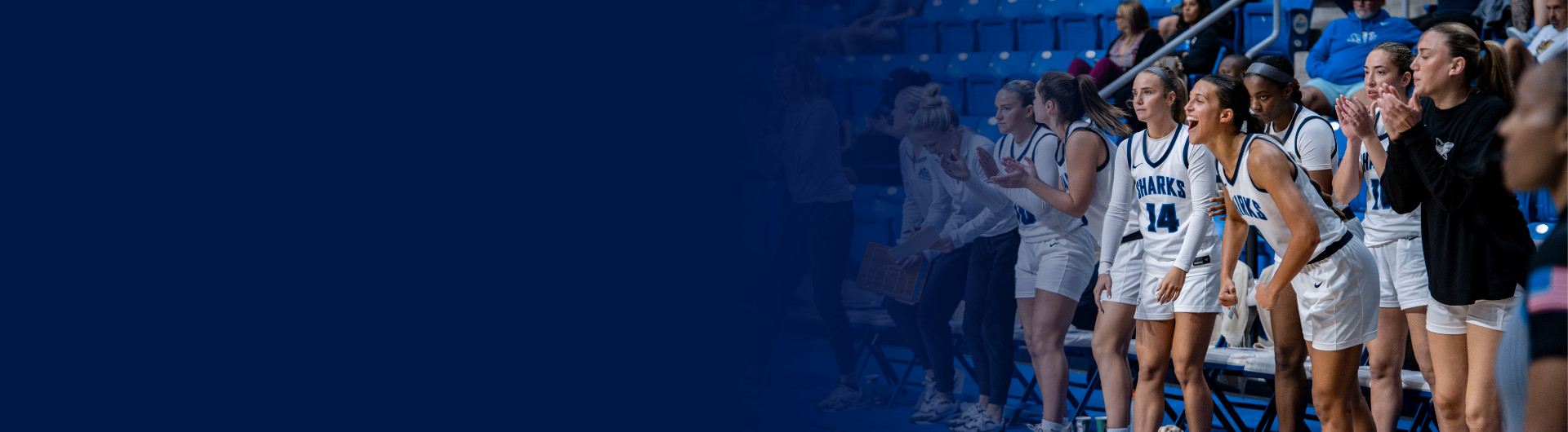 NSU Women's basketball team cheering from the sideline