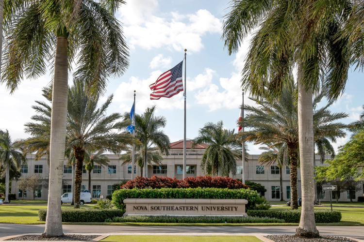 Front view of campus with American flags