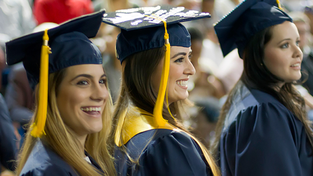 Group of NSU graduates smiling during a ceremony