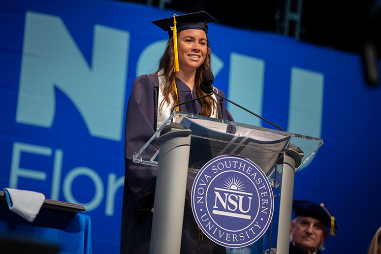 NSU graduate speaking on stage during the ceremony