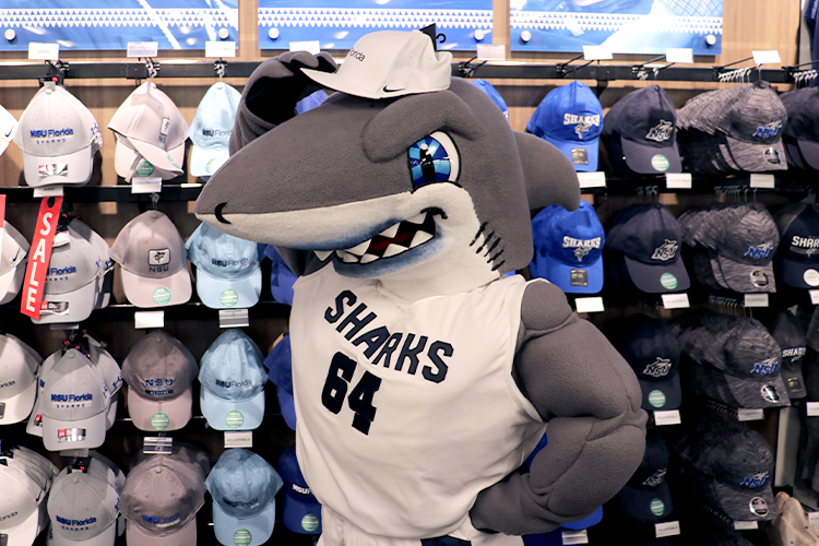 Razor the shark wearing an NSU hat at the campus shop