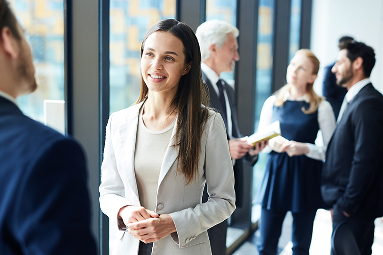 Woman speaking to her colleague in a networking event.