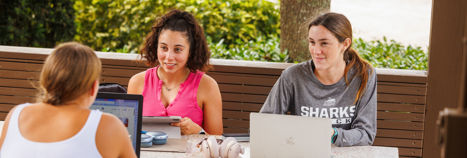 NSU students sitting around campus speaking