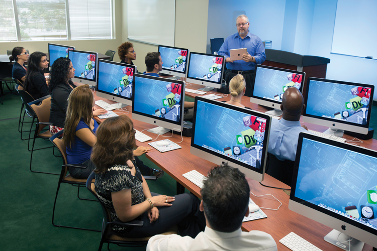 Computing group of students in lab classroom with instructor.