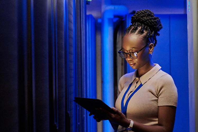 Graduate professional working in a server room