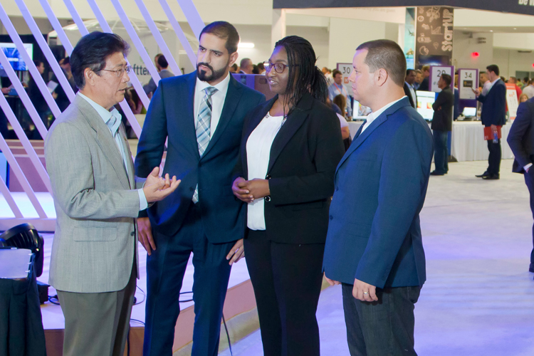 Group of graduates in the computer engineer field speaking at event