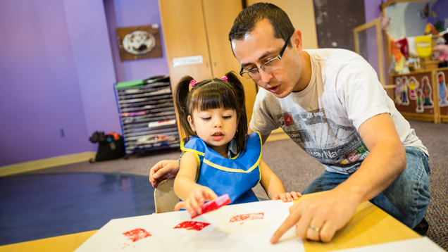 Developmental specialist working with child on table