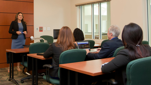 Education curriculum instruction woman in front of classroom