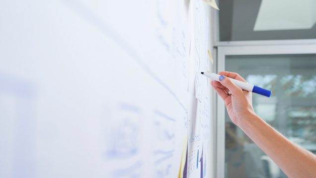 Educator writing in white board