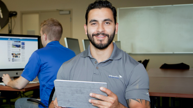 IT sharks staff in office holding digital tablet