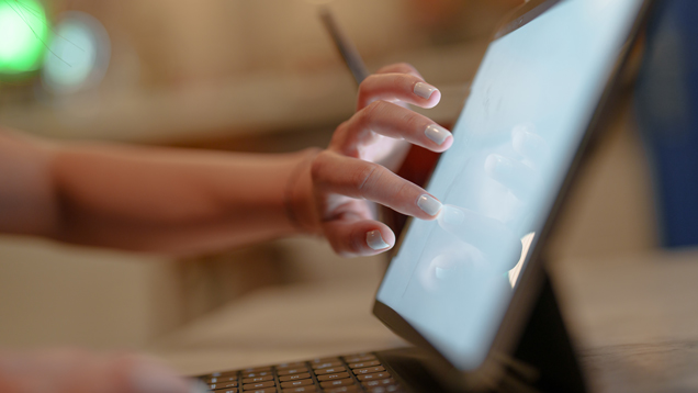 Person hand touching computer screen looking at program details closeup