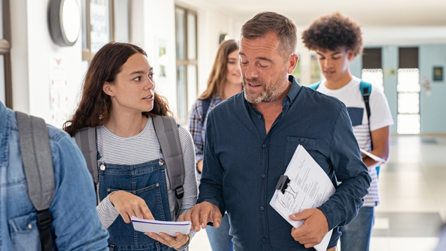 Teacher speaking with student