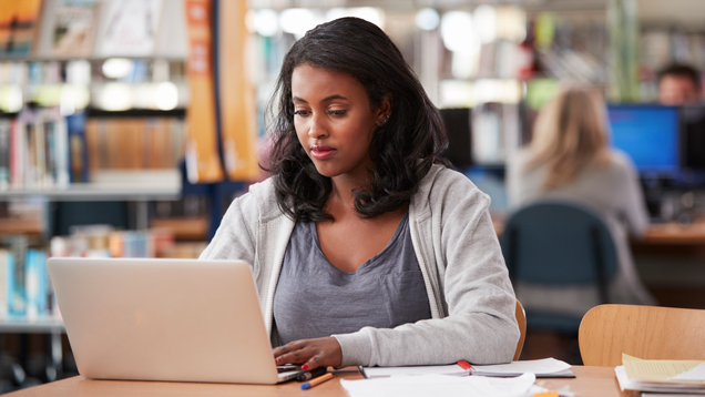 Woman working on laptop at the library