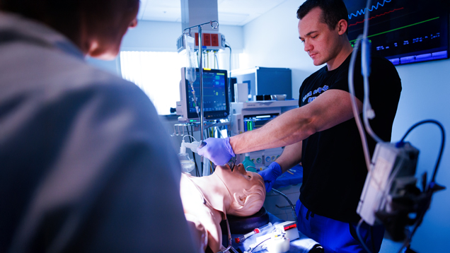 Anesthesiology student doing intubation to mannequin at simmulation lab