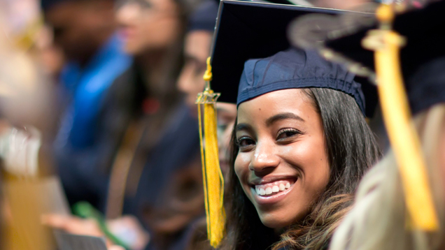 NSU graduate at commencement smiling