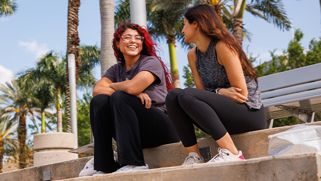 NSU students laughing outside of campus