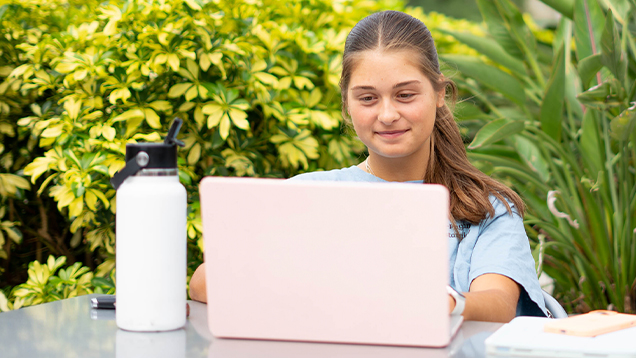 Student using a laptop outdoors