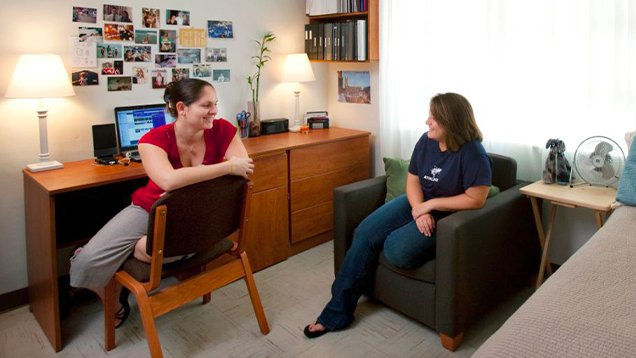 Two NSU students talking in their room