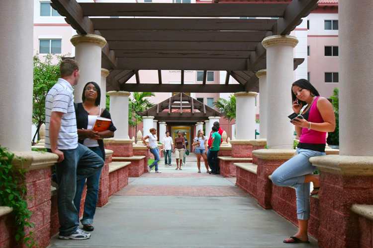 Group of students standing outside of The Commons building