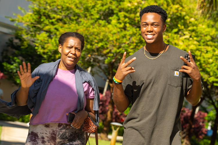 Student and his mother smiling at the camera