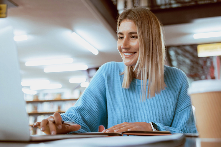 Student using a laptop in the library