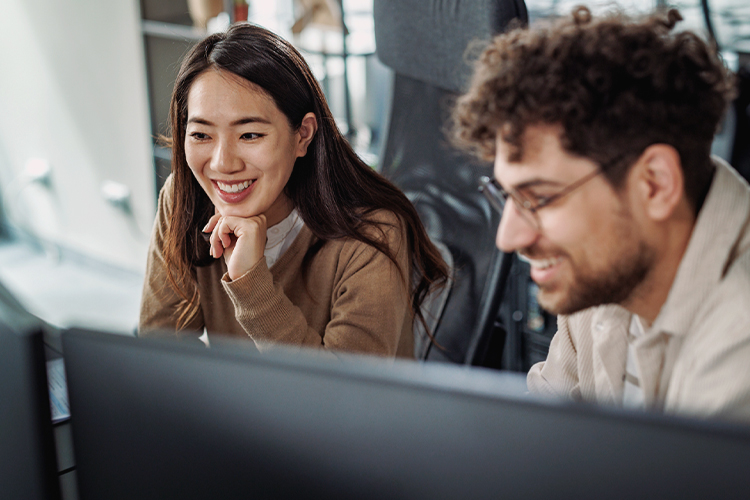 Two people using a computer