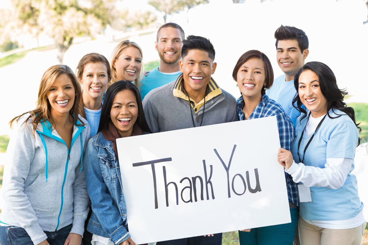 Students with a thank you sign to professors