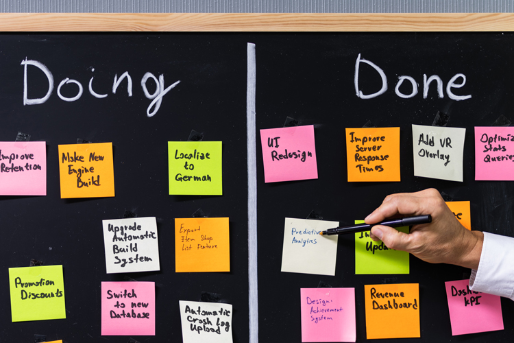 Hand pointing to sticky notes