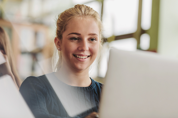 Student using her laptop close up