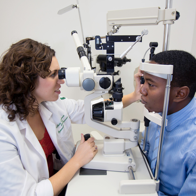 Optometry student doing eye exam to patient