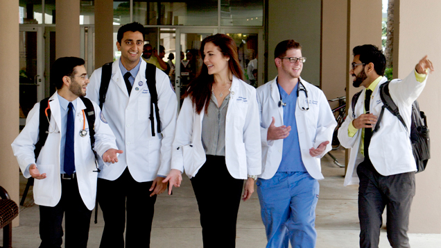 NSU osteopathic dual degrees students talking while walking on campus outdoors