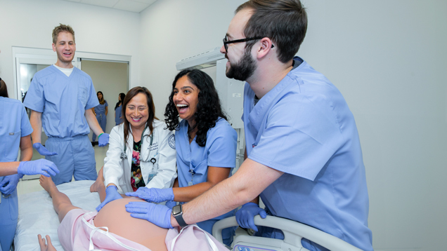 NSU students practicing with pregnant dummy