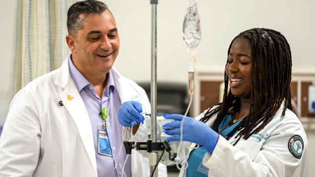 Nursing student receiving professor guidence in clinic