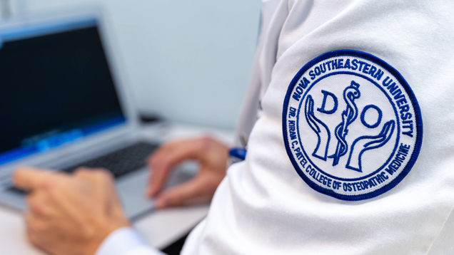 Osteopathic student using laptop closeup