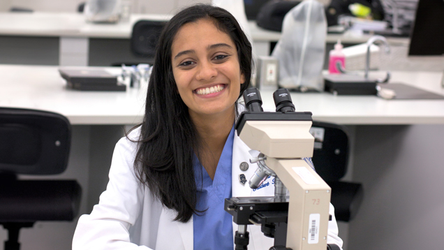 Student doing lab research with microscope