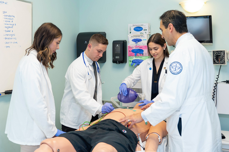 NSU students doing medical procedure dummy.