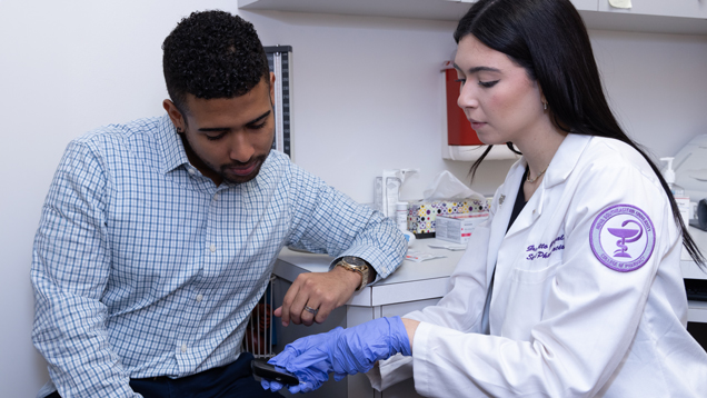 Pharmacist student using glucometer