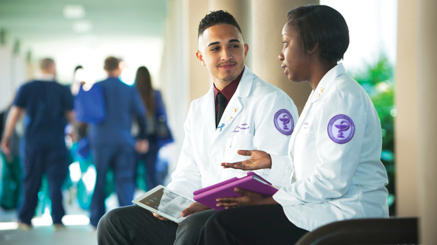 Pharmacy students talking on campus outdoors