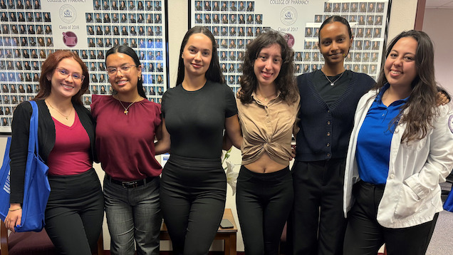 Group of students standing with pharmacy student on Shadow Day.