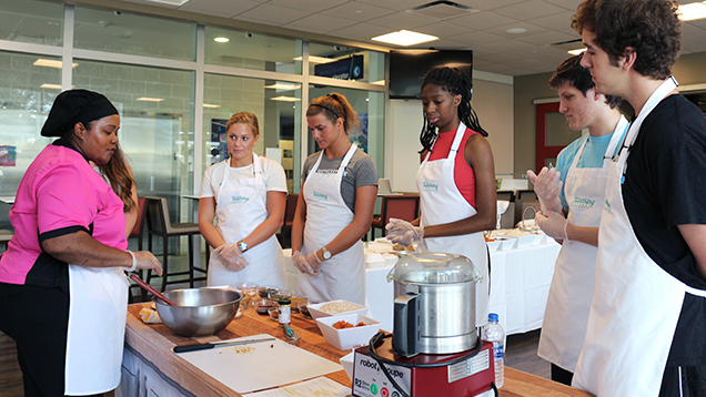 NSU students watching a chef prepare a meal