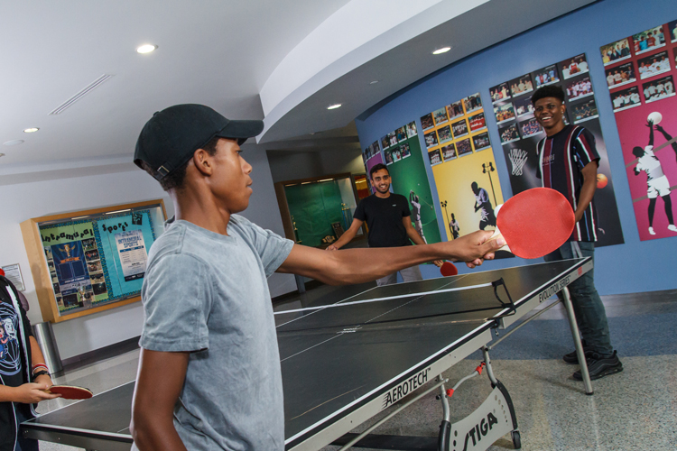 Students playing ping-pong recreational area