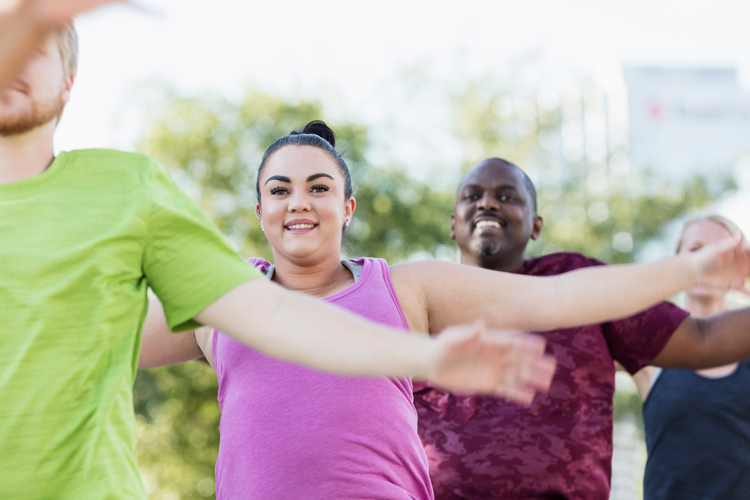 Weight loss program group doing outdoor workout