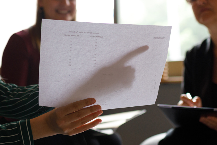 Person reading transcripts paper