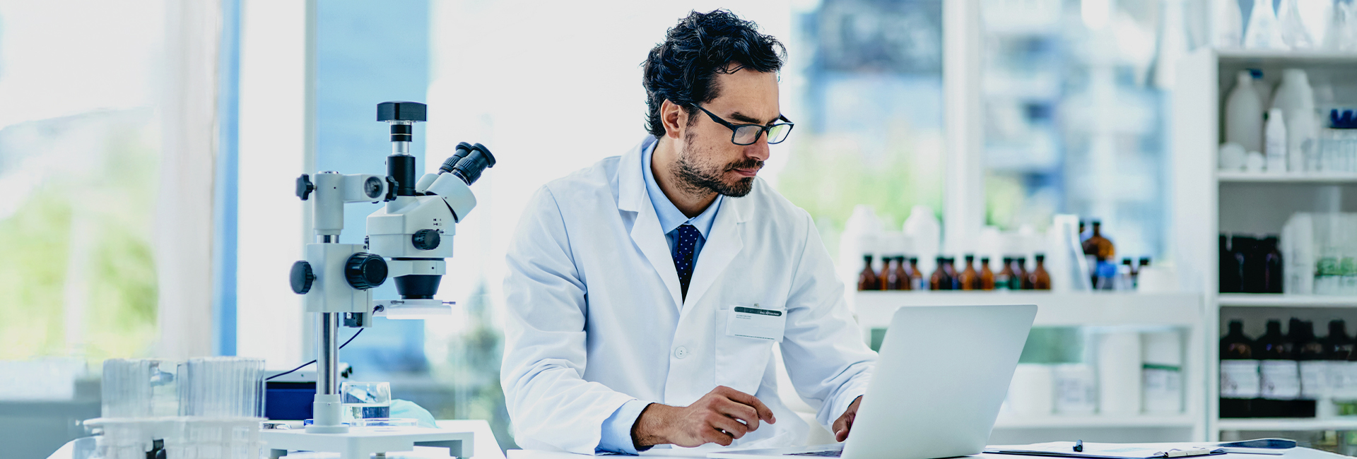 Scientist using a laptop in a lab