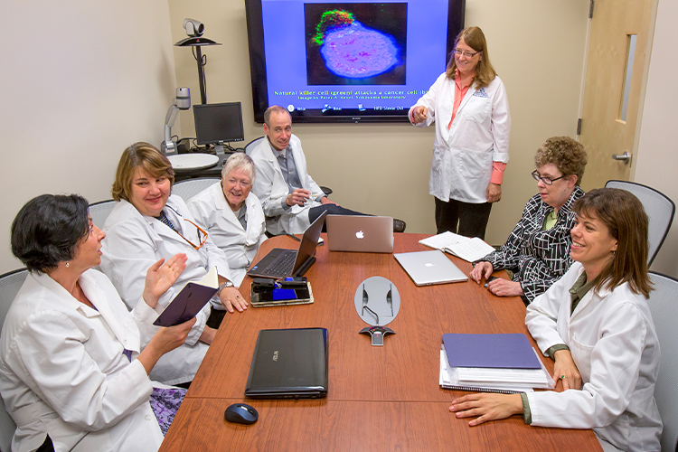 Group of scientists in a meeting watching a presentation