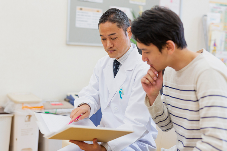 Man reviewing a document with a doctor