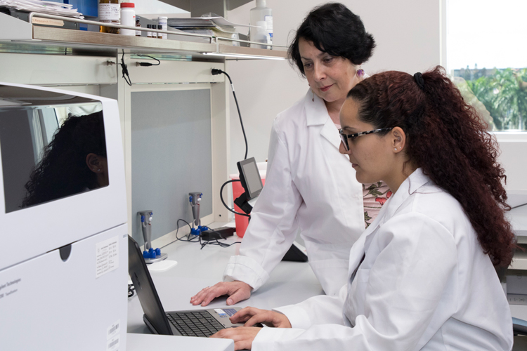 NSU professor and student looking at computer screen