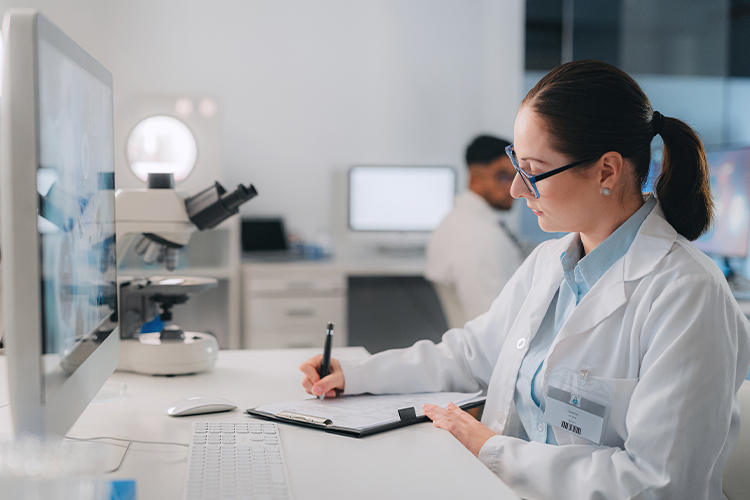 Scientist doing research and writing in laboratory